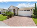 Exterior of house with brick driveway and manicured landscaping at 3378 Sagebrush St, Harmony, FL 34773