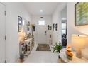 Bright foyer with white tile flooring, decorated tables, and ample natural light at 3378 Sagebrush St, Harmony, FL 34773