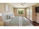 Cozy bedroom with neutral walls, a large window, and an ensuite bathroom at 352 Alicante Ct, Davenport, FL 33837