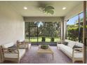 Relaxing screened lanai featuring brick pavers, comfortable seating, and a ceiling fan at 352 Alicante Ct, Davenport, FL 33837