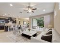 Open-concept living room and kitchen with tile flooring, a ceiling fan, and lots of natural light at 352 Alicante Ct, Davenport, FL 33837