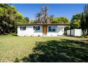 Charming single-story home with a freshly painted exterior, a well-manicured front yard, and a carport at 453 E Jessup Ave, Longwood, FL 32750