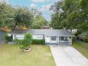 Charming single-story home featuring a well-manicured lawn and inviting front porch at 4760 Danzig Ct, Orlando, FL 32811