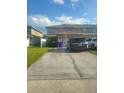 Townhouse exterior with attached garage and driveway; parked vehicles and trash receptacles visible at 4819 Apple Blossom Ln, St Cloud, FL 34771