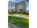 Inviting two-story home featuring neatly trimmed hedges and a well-manicured front lawn at 4819 Apple Blossom Ln, St Cloud, FL 34771