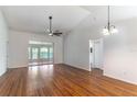Spacious living room with wood floors, fan and sliding doors to lanai at 5426 Astor St, Leesburg, FL 34748