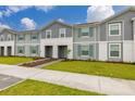 Inviting townhomes with well-maintained lawns, creating a pleasant and appealing street view at 971 Paradise Dr, Davenport, FL 33897