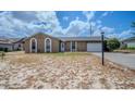 Single-story home with a lawn that requires landscape maintenance at 987 Trumbull St, Deltona, FL 32725