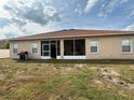 Backyard with screen door and grill, perfect for outdoor cooking and relaxation at 1029 Dampierre Ct, Kissimmee, FL 34759