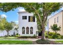 Attractive two-story home featuring a manicured lawn, neat shrubs, and a mature shade tree at 1047 Banks Rose St, Kissimmee, FL 34747