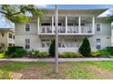 Charming two-story home with a beautiful covered porch and manicured landscaping, creating a welcoming curb appeal at 1211 Celebration Ave # 102, Celebration, FL 34747