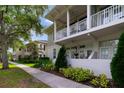 Low angle shot showing exterior with a second story covered porch and view of other homes in the neighborhood at 1211 Celebration Ave # 102, Celebration, FL 34747