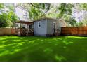 Rear exterior of home with small porch area and a fenced yard at 1407 Noble Pl, Orlando, FL 32801