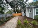 Backyard features a new fence, side deck, and a well-maintained yard at 1407 Noble Pl, Orlando, FL 32801