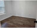 Bright bedroom with updated flooring and fresh paint, awaiting your personal touch at 1521 Nieuport Ln, Orlando, FL 32805