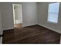 Clean bedroom featuring hardwood flooring, neutral paint, and natural light at 1521 Nieuport Ln, Orlando, FL 32805