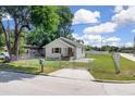 Cozy fenced home featuring a minimalist design, a mailbox, and a well-maintained lawn at 1521 Nieuport Ln, Orlando, FL 32805