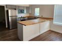 Eat-in kitchen featuring new stainless steel appliances, ample countertops, and shaker cabinets at 1521 Nieuport Ln, Orlando, FL 32805