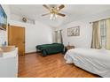 Bright bedroom with hardwood floors, two windows, ceiling fan and an ensuite bathroom at 1543 Reade Cir, St Cloud, FL 34772