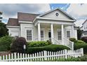 Inviting home boasts a well-manicured lawn, white picket fence, and a covered porch with stately columns at 204 Celebration Blvd, Celebration, FL 34747