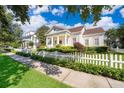 Inviting single-Gathering home featuring a classic white picket fence and beautiful street view at 204 Celebration Blvd, Celebration, FL 34747