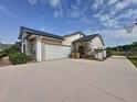 Side view of the home with a two-car garage, an ample driveway and meticulous landscaping at 2150 Emperor Dr., Kissimmee, FL 34744