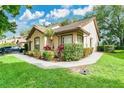 Inviting single-story home showing manicured landscaping and the side yard at 2473 Saint Augustine Blvd, Haines City, FL 33844