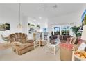 Bright living room with neutral carpet, adjacent to the kitchen and dining area at 2473 Saint Augustine Blvd, Haines City, FL 33844