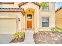 Charming home with a well-manicured lawn, arched entrance, and an elegant front door at 2628 Tranquility Way, Kissimmee, FL 34746