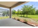 Covered back porch offering views of the screen enclosed pool and lush green backyard at 3138 Dark Sky Dr, St Cloud, FL 34773