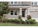 Close up of front porch with beautiful landscaping, updated front door, and stone accents at 3138 Dark Sky Dr, St Cloud, FL 34773