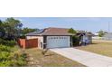 Aerial view showcasing the home's solar panels, two-car garage, and fenced backyard at 402 Ohio Way, Kissimmee, FL 34759