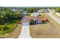An aerial view of the house showing the surrounding neighborhood and well maintained lawn at 402 Ohio Way, Kissimmee, FL 34759