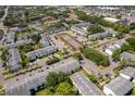 A community aerial view showcasing building exteriors, green spaces, parking, and tennis courts at 4403 S Semoran Blvd # 2, Orlando, FL 32822