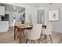 The dining room features modern decor and an adjacent view into the kitchen with stainless steel appliances at 4420 Lake Lawne Ave, Orlando, FL 32808