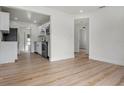 Bright living space showcasing an open concept layout with seamless flow to the kitchen with modern stainless steel appliances at 4420 Lake Lawne Ave, Orlando, FL 32808