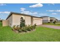 Low angle of this home with a brick driveway, well maintained landscaping and a front two car garage at 527 Amadoras Way, St Cloud, FL 34771