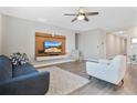 Spacious living room featuring a modern entertainment center and plenty of natural light at 527 Amadoras Way, St Cloud, FL 34771