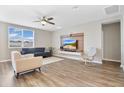 Bright living room with light-colored hardwood floors, neutral walls, and modern furniture at 527 Amadoras Way, St Cloud, FL 34771