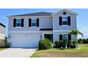 Inviting two-story home with a two-car garage, well-maintained lawn, and welcoming front entrance at 673 Sarner Pass Way, Winter Haven, FL 33881