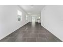 Spacious living room featuring gray tile flooring and lots of natural light at 7728 Stone Creek Trl, Kissimmee, FL 34747