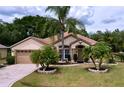 Inviting single-Gathering home with a well-maintained lawn and beautiful landscaping at 1011 Dampierre Ct, Kissimmee, FL 34759