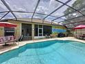 Private screened-in pool area, complete with patio furniture, a grill, and a mural at 1011 Dampierre Ct, Kissimmee, FL 34759