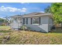Exterior view of a home with gray siding, black shutters, and a cozy front porch at 1024 Cohassett Ave, Lake Wales, FL 33853