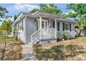 Exterior of home with a inviting front porch, gray siding, and walkway at 1024 Cohassett Ave, Lake Wales, FL 33853