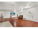Spacious living room with hardwood floors, white walls, and a decorative front door at 1055 N Chickasaw Trl, Orlando, FL 32825