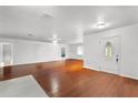 Bright and airy living room with beautiful hardwood floors and a decorative front door at 1055 N Chickasaw Trl, Orlando, FL 32825