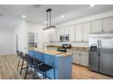 Modern kitchen features stainless steel appliances, granite countertops, and breakfast bar at 1115 Mosaic Dr, Celebration, FL 34747