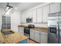 Modern kitchen features stainless steel appliances, granite countertops, and ample storage space at 1115 Mosaic Dr, Celebration, FL 34747