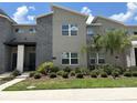 Contemporary two-story townhouse featuring stone accents, well-kept landscaping, and a modern architectural style at 1160 Kingsbarn St, Davenport, FL 33896